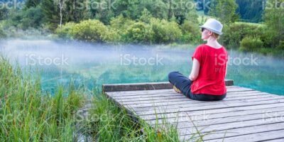 Woman, sitting, red, T-Shirt, pier, blue, lake, fog